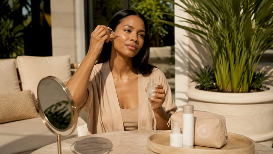 Woman applying serum in bright bathroom