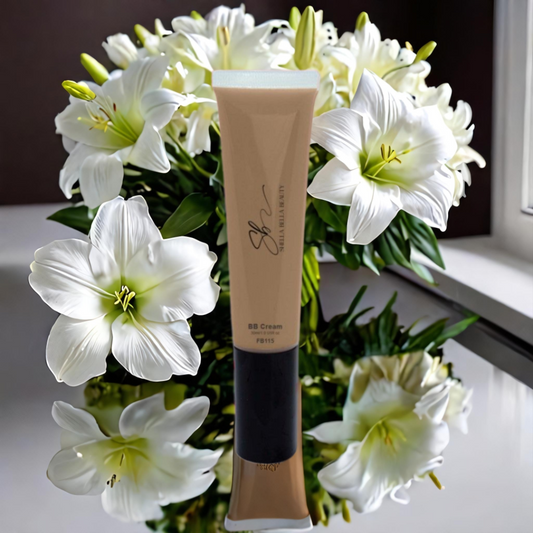 A tube of RadiantBlend Birch BB Bliss Cream placed against a backdrop of white lilies, suggesting a natural and radiant complexion effect.